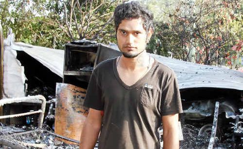 Indian visitor Chatten Duggal was calling the fire brigade while an unidentified Nepalese man removed a child from this caravan before it was engulfed in flames at the Childers Central Caravan Park yesterday. Indian visitor Chatten Duggal was calling the fire brigade while an unidentified Nepalese man removed a child from this caravan before it was engulfed in flames at the Childers Central Caravan Park yesterday.